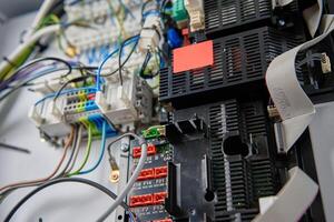 Close-up view of wiring system and circuit board inside electrical control panel. Electrical components used for automation and regulation of various systems photo