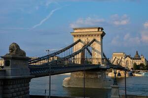 Szechenyi Chain bridge in Budapest at Sunset. Famous bridge over Danube river connecting Buda and Pest. Historical architecture in Hungary photo