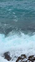 A stormy sea with crashing blue waves under dark clouds near the coast of Budva Montenegro. The powerful ocean swells and dramatic sky create a breathtaking display of natures force. video