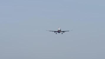 A distant view of a jet plane approaching for landing, with its headlights. Airliner arrives video