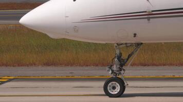 View of nose and front landing gear of a small private passenger jet airplane video