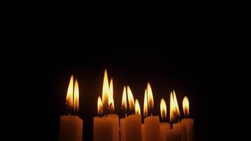 A collection of glowing candles flickering in the dark, evoking serenity, tranquility, and reflection video