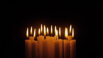 concept of sadness and mourning set of candles flame on black background video