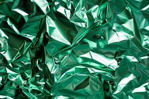 Crumpled metallic green paper texture photo