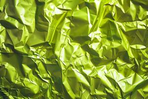 Crumpled metallic lime green paper texture photo