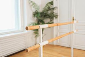 Empty ballet dance studio with barre. Professional ballet barre for stretching practicing dancing positions in dance school Dance hall ready for ballet class training. Ballet school photo
