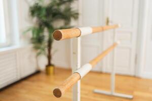 Empty ballet dance studio with barre. Professional ballet barre for stretching practicing dancing positions in dance school Dance hall ready for ballet class training. Ballet school photo