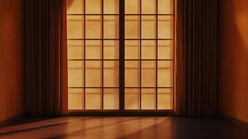 Warm light through window panes casts shadows on a floor in an empty room with hanging curtains, showcasing light and architectural details. photo