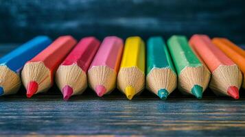 A vibrant collection of colored pencils arranged in a row, showcasing a spectrum of hues and the potential for artistic expression. photo