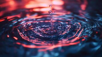 Water droplet impact creates ripples with blue and red lighting, illustrating fluid dynamics and artistic expression with abstract appeal. photo