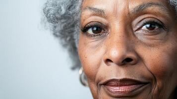 Close-up captures the grace of aging with a woman's kind eyes and silver hair, revealing a life beautifully lived in her expression. photo