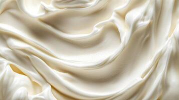 Close-up of swirling white cream texture, rich and smooth. Abstract pattern, culinary aesthetic, inviting and palatable backdrop. photo