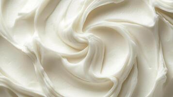Close up of white frosting or cream swirls filling the frame. A smooth and delicious addition to any dessert or baking project. photo