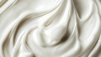 Close-up of swirls of smooth, white cream. The texture is rich and glossy, creating a sense of luxurious skincare and beauty products. photo