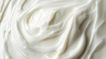 Creamy swirls of smooth, white dairy product create a visually appealing and luxurious texture. Perfect for food or cosmetic applications. photo
