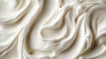Close-up of a smooth, swirling white cream texture, creating a sense of richness and luxuriousness. Perfect for culinary or cosmetic visuals. photo