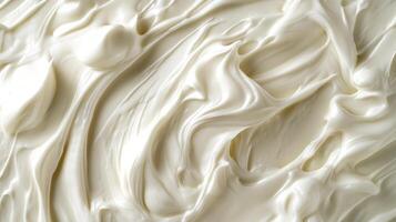 Close-up shot of thick, creamy, white textured substance, showcasing swirls and ridges, ideal for backgrounds emphasizing smoothness. photo