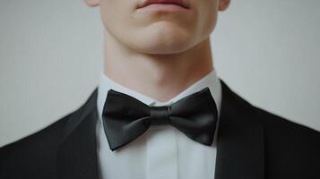 A sophisticated formal image, a man's bow tie and suit jacket suggest refined elegance. Classic, sharp details convey a sense of style and class. photo