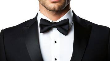 Close up of a man wearing a black tuxedo with a white shirt and black bow tie for a formal event or celebration. Sharp outfit. photo