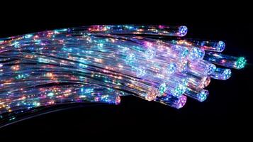 A mesmerizing display of fiber optics, radiating vibrant colors against a stark black backdrop, creating an ethereal and futuristic ambiance. photo