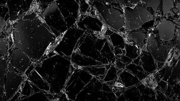 Intricate network of cracks spreading across a dark, reflective surface, creating a complex web of shattered patterns and sharp angles. photo