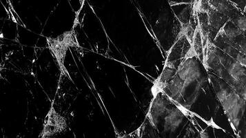 Cracked surface with jagged lines and sharp edges in black and white. Illustrates fragility, fracture, and damaged material under pressure. photo