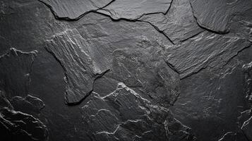 Detailed stone texture of dark grey slate, presenting a rough, layered surface with subtle highlights emphasizing rugged formations. photo