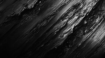 Dramatic, high-contrast abstract showcasing textures of rock formations with sharp ridges and deep shadows in monochromatic tones. photo