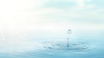 Water drop falling into still surface creating ripples. Soft light and airy atmosphere create a tranquil, serene feeling. photo