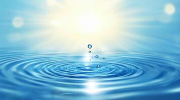 Water droplets create mesmerizing ripple effects on a bright, serene, blue water surface. Rays of sunlight shine from above. photo