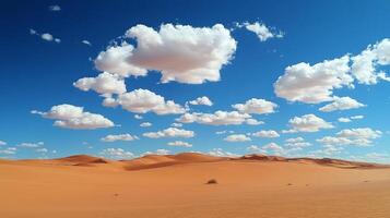 Scenic desert landscape featuring rolling sand dunes under a blue sky dotted with fluffy white clouds in a serene and remote setting. photo
