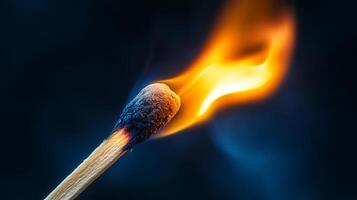Close-up of a wooden matchstick igniting, showing bright orange flame against dark background. Macro shot of fire in controlled setting. photo