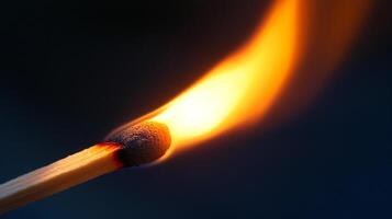 Illuminating the dark with a single match, symbolizing light, power, and fragility. The match is burning against a dark background. photo