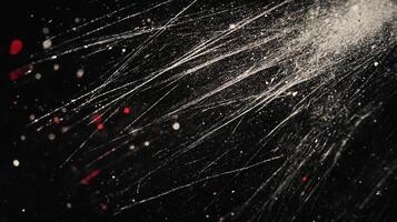 Abstract splatter of white paint on dark background evokes a sense of controlled chaos and energetic expression with red accents. photo