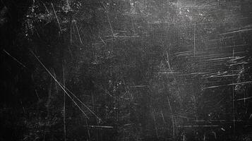Abstract image of a heavily scratched black surface, illuminated from the upper right, creating contrast and highlighting the textured detail. photo