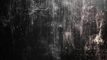 Grungy black surface texture, showing scratches and dust. An abstract design for use as background or overlay to add an distressed feel photo