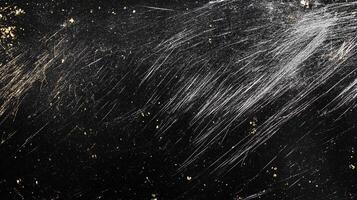 Abstract image of a dark textured surface with scratches, with a speckled appearance, reminiscent of a celestial scene with light trails. photo