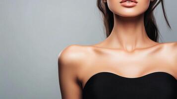 Elegant view of a woman's upper body, showing her shoulders, neck, and upper chest, highlighting smooth skin and simple fashion. photo