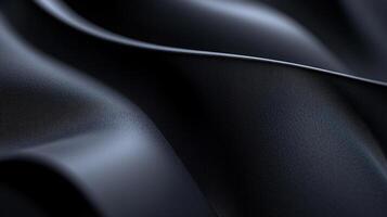 A close-up of sleek black fabric, highlighting its smooth surface and intricate folds that create a powerful visual impact while representing sophistication and elegance. photo