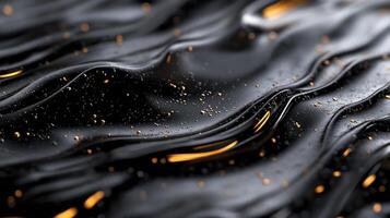 This image showcases an elegant flowing black surface with shimmering golden highlights, evoking a sense of luxury and sophistication in its abstract form. photo