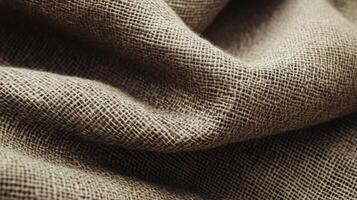 Intricate texture of burlap fabric captured in detail, ideal for rustic and natural decor themes, highlighting the organic feel and earthy color tones of the material. photo
