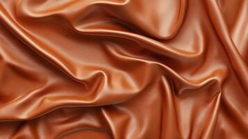 Coppery fabric, like a satin curtain. The material looks as though it flows like liquid copper, with a smooth shiny look and feel. photo