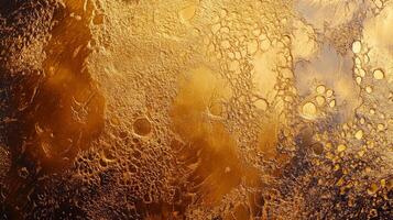 Golden textured surface with craters. An abstract view of a planet landscape in rich gold colors. Unique pattern and design. photo