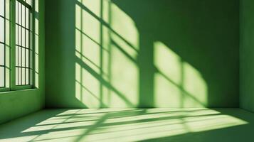 Light and shadows create an abstract play on a green wall, casting interesting patterns on the floor and walls. photo