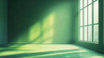 A minimalist green room basks in the soft glow of sunlight streaming through a large window, casting shadows across the floor and wall. photo