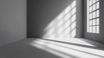 A grayscale architectural view of a stark room with sunlight streaming through a window, casting graphic shadows and highlighting the space. photo