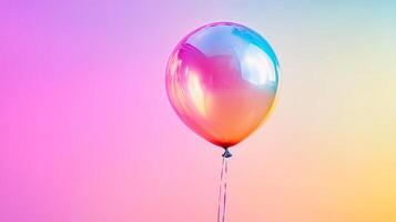 Iridescent balloon floats against a soft, gradient background, showcasing vibrant colors and smooth transition in a minimalist composition. photo