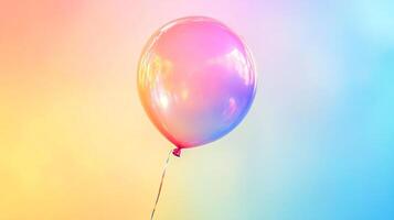 Shiny balloon with rainbow gradient. Floating elegantly against soft pastel background. Symbol of celebration, joy and happiness. photo