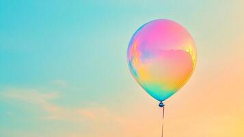 A vibrant, iridescent balloon floats against a gradient sky, a single string trailing below, creating a joyful and whimsical scene. photo