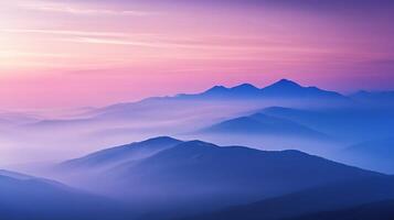 A beautiful mountain range with misty valleys is painted with the colorful hues of a vibrant sunset, creating a tranquil, serene vista. photo
